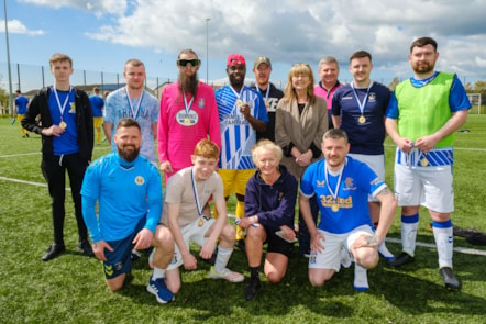 Cllr Clare Maitland and Craig McArthur with participants from the football tournament