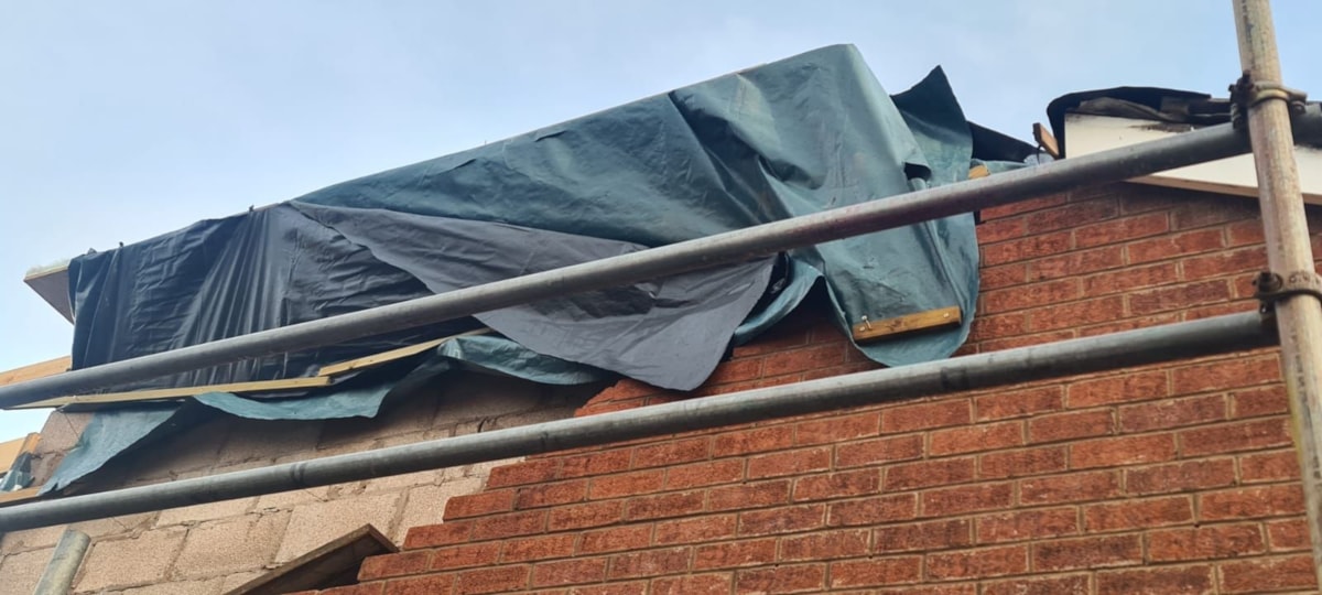 One of the badly repaired roofs