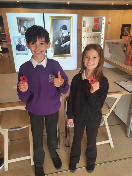Elgin High School pupils Harrison and Skye aboard Poppyscotland's interactive travelling museum bus called Bud which visited Elgin's Seafield Primary School.