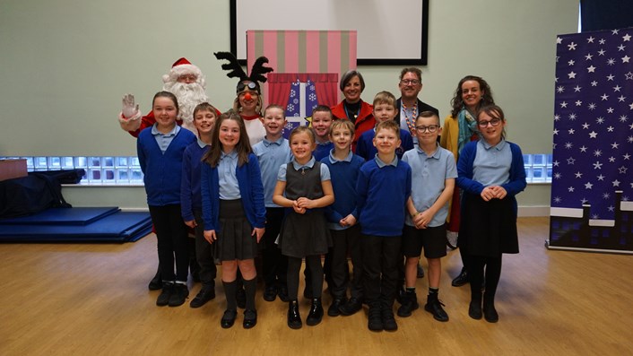 Festive road safety pantomime delights pupils with laughter and life-saving lessons: Councillor Hayden and Councillor Holroyd-Case with Santa, Rudolph and pupils at Thorpe Primary School