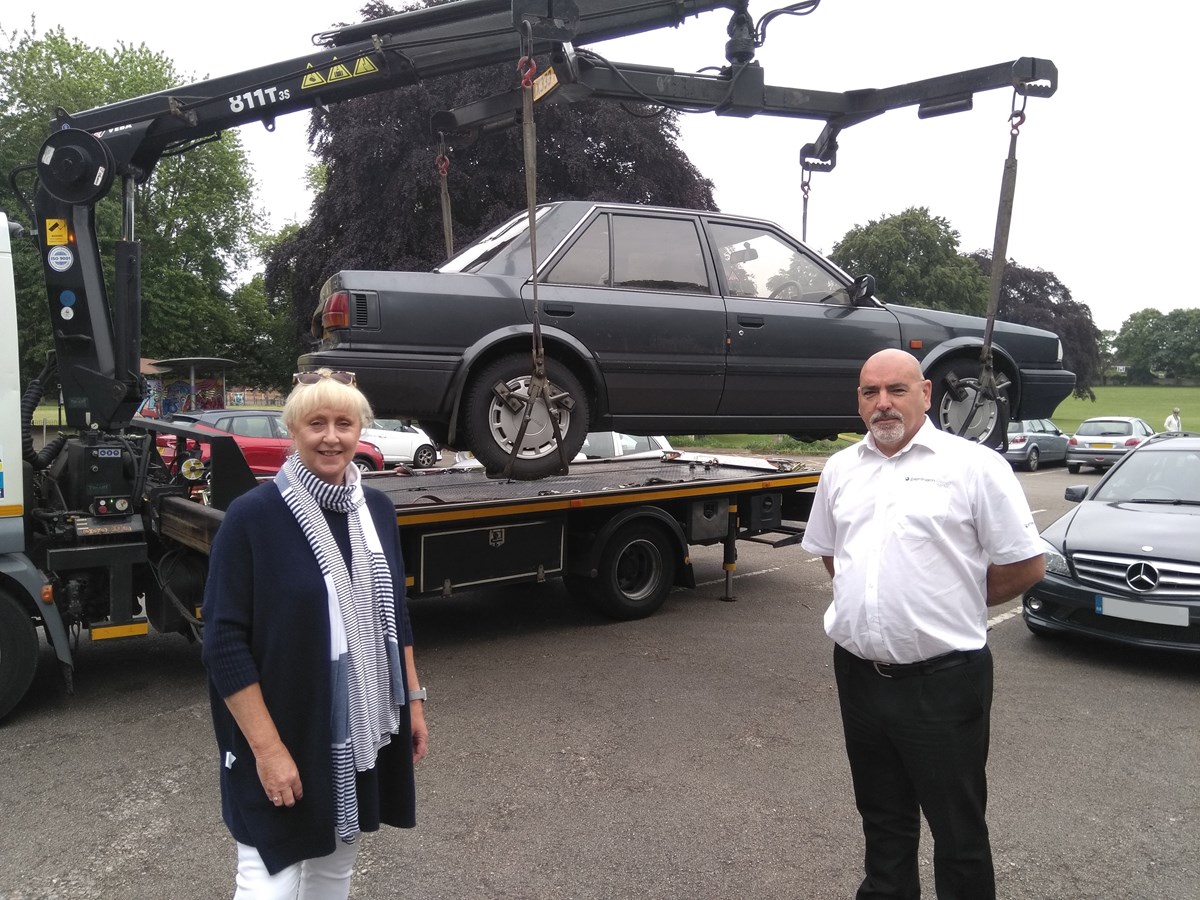 Councillor Karen Shakespeare and Darren Crombie from Penhams with an untaxed vehicle being removed from the highway