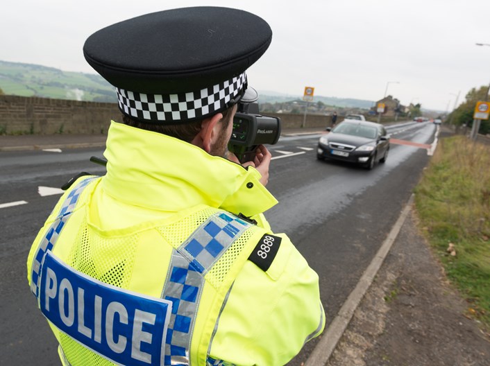 New traffic enforcement programme targeting dangerous driving in Leeds begins: Police officer with handheld speed camera