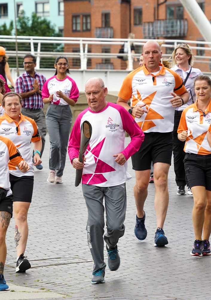 Peter McGouran carrying the Queen's Baton Relay: Peter McGouran carrying the Queen's Baton Relay at Leeds Dock