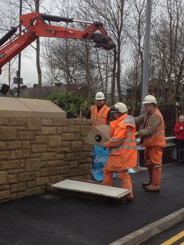 Rebuilt bridge reopens as electrification of the railway in the north west progresses: The final stone of the Henrietta Street bridge is lifted into place