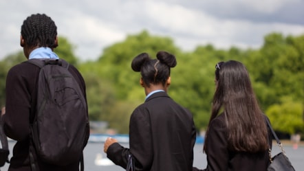 three young people in school uniforms