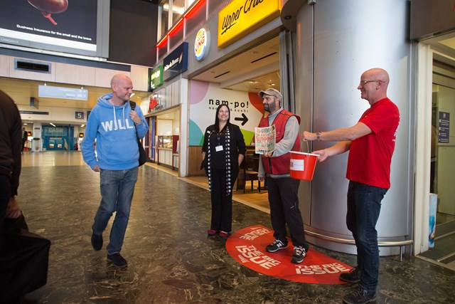 Big Issue vendor pitch: UK's first permanent Big Issue vendor pitch inside a station. Pictured: Rebecca Richards, Euston station support assistant, David Manso, Big Issue Vendor and Stephen Robertson, CEO of The Big Issue Foundation