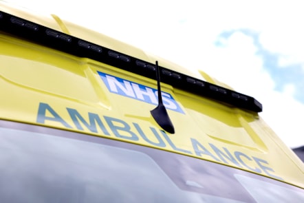 The top of an ambulance with the text NHS and Ambulance shown.