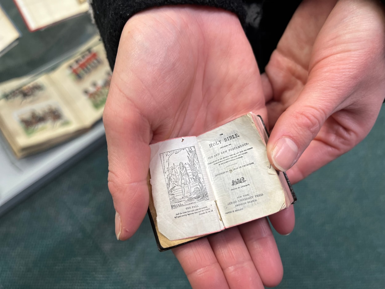 Library Christmas books: A miniature copy of the King James Bible, which made headlines around the world when it was rediscovered during lockdown, is among the books on display, giving visitors a rare chance to see a highly unusual example of the original Christmas story.
Little enough to fit in the palm of a hand, and with text so tiny it can only be read with a magnifying glass, the Bible dates from around 1911, and is thought to be one of the smallest examples of its kind anywhere in the world.