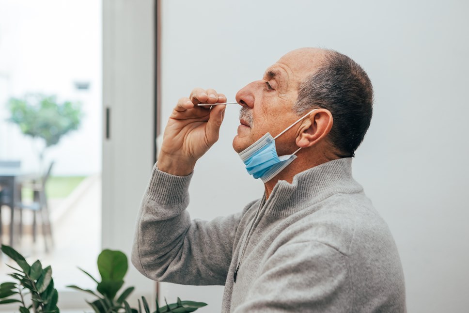 Man administering a covid swab test himself