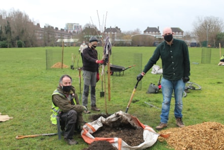 Russell Miller, from Tree Musketeers, with a volunteer and Mayor of Hackney, Philip Glanville