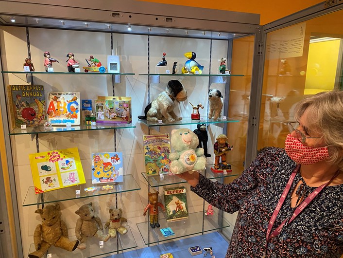 Abbey House toy display: Kitty Ross, Leeds Museums and Galleries' curator of social history with an 80s classic Care Bear, which sold over 40 million worldwide between 1983 and 1987.
