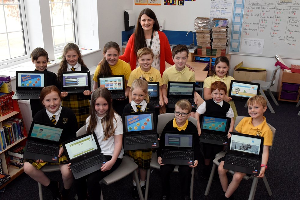 Smiles all round as community donates laptops to Fenwick Primary
