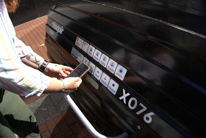 Hooplr Cycle Hangar Launch 3: A person using their app to unlock the hangars