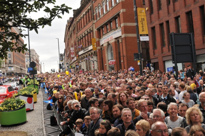 Leodis TdF gallery: Crowds line the streets on The Headrow in Leeds city centre, straining to see the riders in the Grand Depart of the Tour de France, which began close by outside Leeds Art Gallery. Thousands of people gathered along the route on July 5, 2014. Credit Leeds City Council.