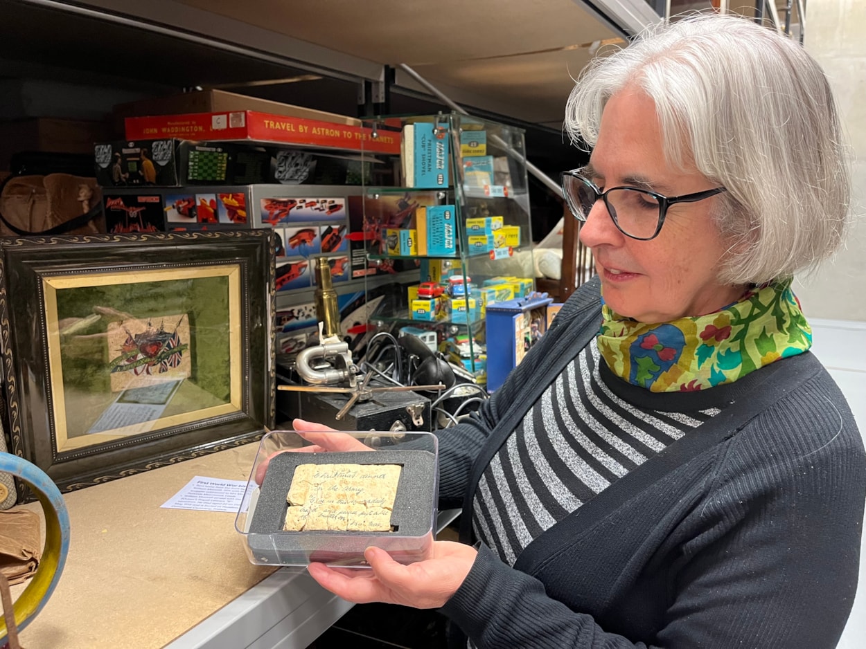 Biscuit messages: Curator Kitty Ross with Private Maxwell's festive message at Leeds Discovery Centre.
The fragile vintage snacks, more than a century old, were originally issued to servicemen as a durable emergency ration but were reputedly so unpalatable, they were instead repurposed as a humorous way of staying in touch with loved ones over Christmas.
Dating from 1914, one of the biscuits currently stored at the Leeds Discovery Centre may have been the final contact Private William Maxwell had with his family before his tragic death.