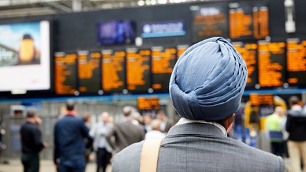 photo - Passenger looking at departure boards