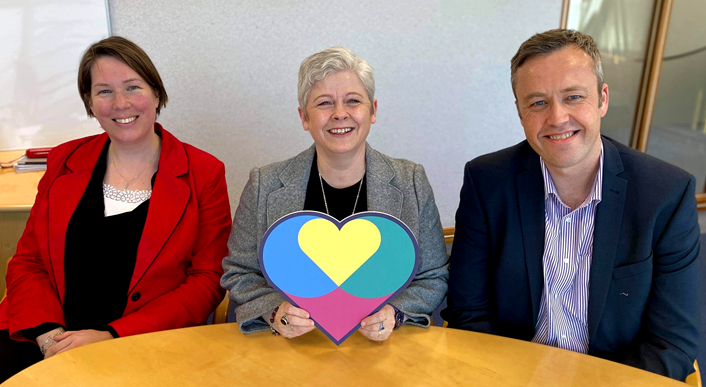 Independent Care Review - EMT (image): SSSC Chief Executive Lorraine Gray (centre) with Director of Regulation Maree Allison (left) and Director of Development and Innovation Phillip Gillespie (right) with the Independent Care Review heart symbol