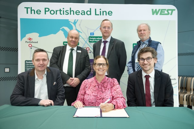 L-R back row Mark Hopwood GWR, Ian Shuffleton Morgan Sindall, Simon Ball Colas Rail, front row L-R Mike Bell North Somerset Council, Helen Godwin Mayor of the West of England, Marcus Jones Network Rail, signing contracts to mark the commencement of work on the Portishead line in May