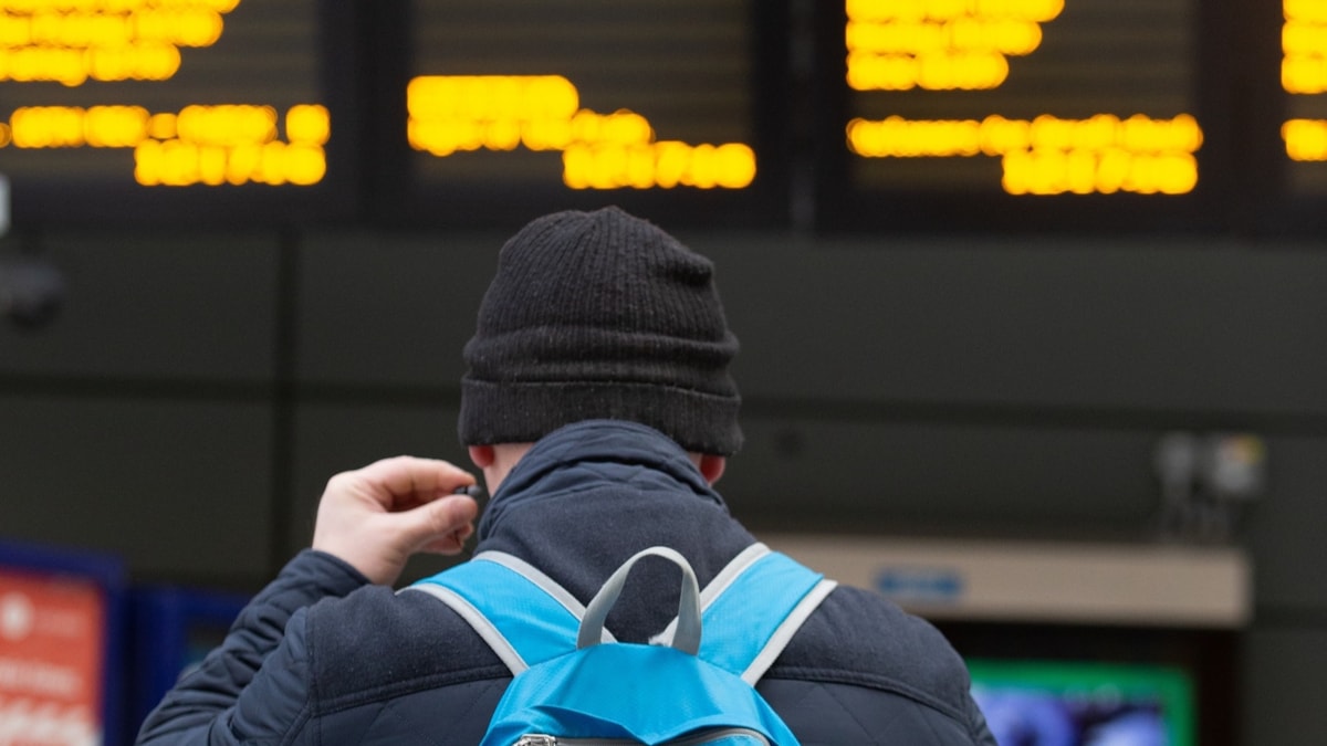 Image shows customer at departure screens cropped-2
