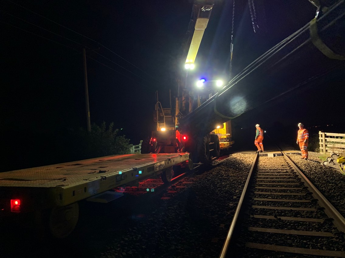 Rail mounted crane installing pipes to pump away Burscough flood water 7 October 2020