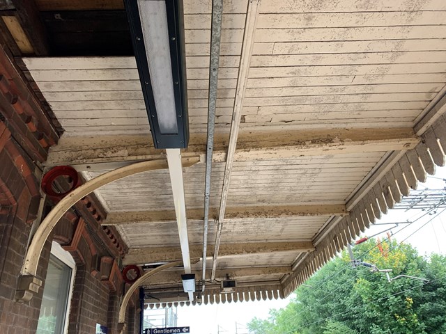 Poor state of timber soffit on Wilmslow station platform canopy before the upgrades: Poor state of timber soffit on Wilmslow station platform canopy before the upgrades