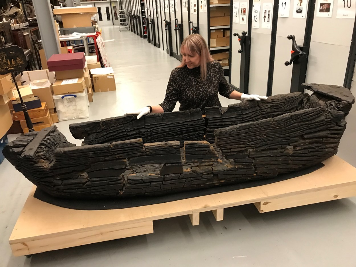 Giggleswick Tarn logboat: Kat Baxter, Leeds Museums and Galleries curator of archaeology with the centuries-old carved logboat, which dates from the 1300s. The  watercraft had lain beneath the soil for more than 500 years before being discovered by Joseph Taylor in 1863 while he was digging some drainage works near Giggleswick Tarn in North Yorkshire.