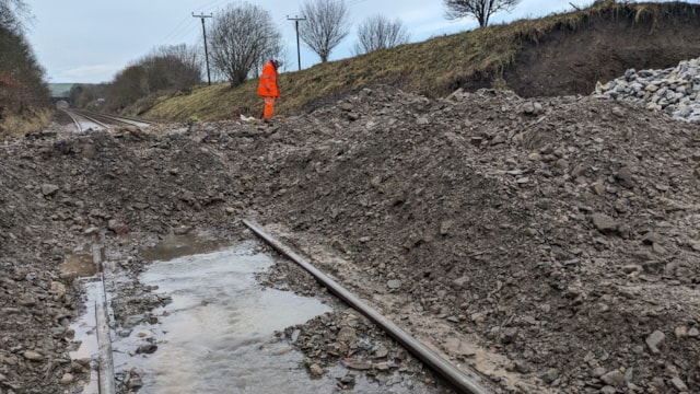 Railway engineers tackle aftermath of Storm Bert in Cumbria: A railway engineer inspects the site where a railway cutting collapsed due to flooding