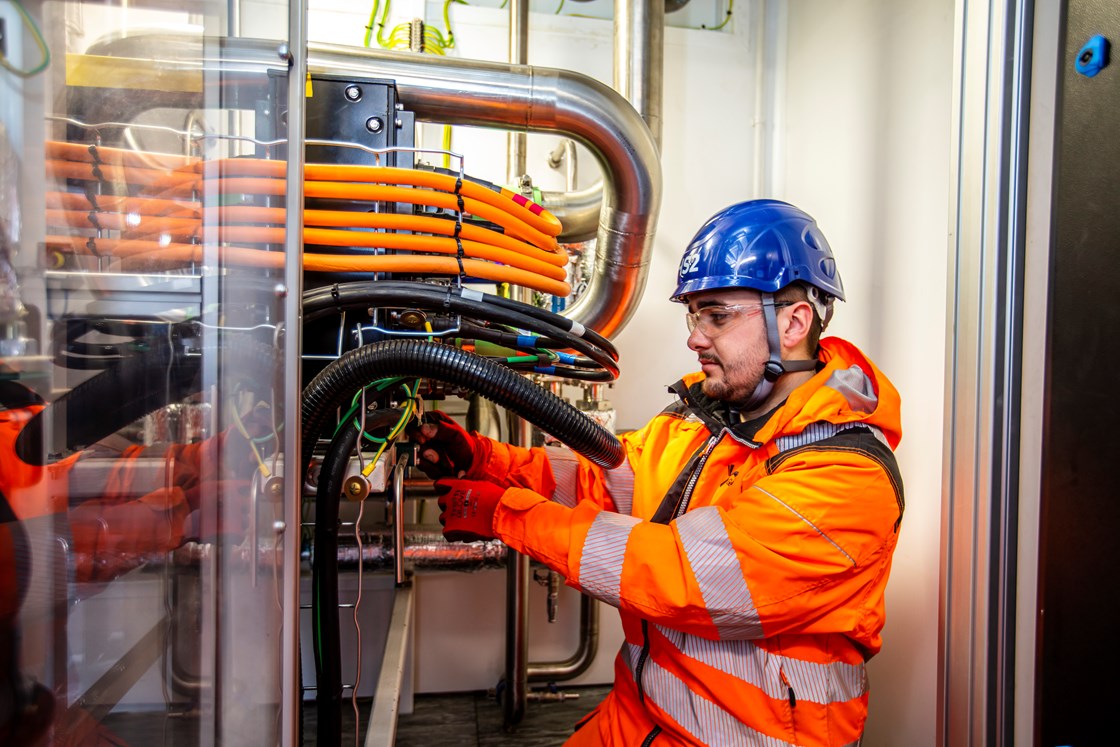 GeoPura representative inspecting the fuel cell area in the HPU