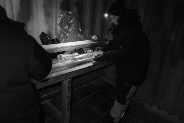 Credit©PNRA IPEV researcher looking at the basal ice core under red light 2