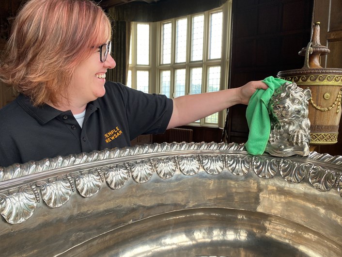 Silver wine cooler: Temple Newsam visitor assistant Rebecca Allott polishes the house's spectacular giant silver wine cooler ready to welcome visitors.