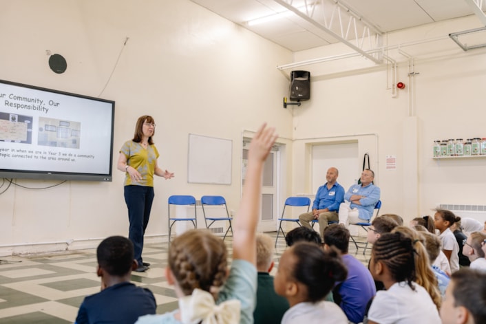 School 2: Beechwood Primary School teacher Melissa Callaby speaks to pupils at the cheque handover event, watched by Damian and Darren Quarmby. Credit: SAZ Media and Wates.