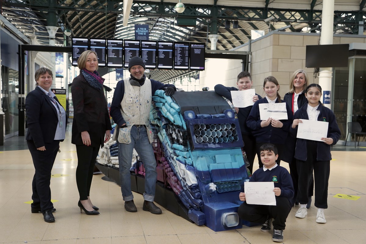 Colleagues from TransPennine Express, artist Andy Pea and children from Year 5 at Adelaide Primary School at the unveiling of the sculpture