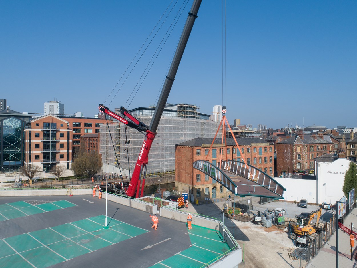 David Oluwale bridge installation: The David Oluwale bridge is lifted into place over the River Aire in Leeds. Engineers working on the David Oluwale bridge completed one of the project’s major milestones over the weekend, with cranes carefully placing the 40 tonne structure over the river where it will connect Sovereign Street to Water Lane. Credit BAM Nuttall.