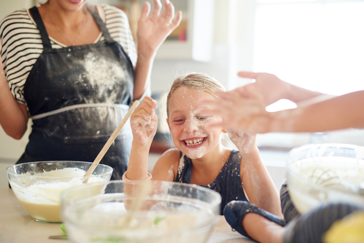 Girls having fun while baking GettyImages-522471250