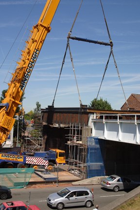 West Derby Road rail bridge: Section of old bridge being removed while road vehicles use contra flow of the dual carriageway
