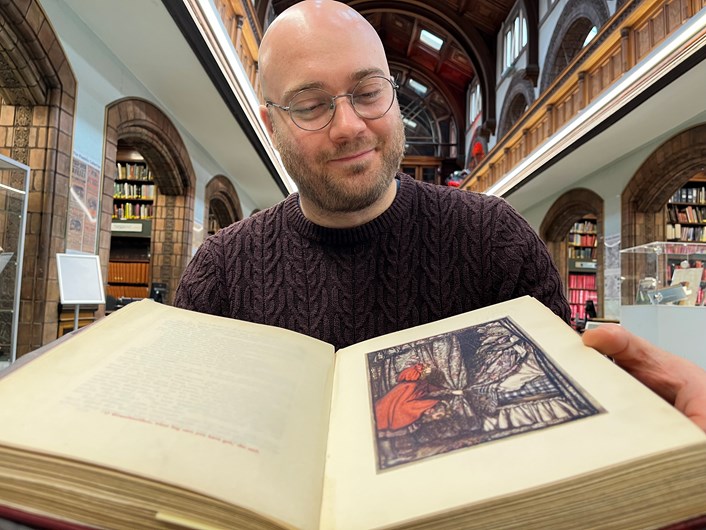 Fantasy at Leeds Central Library: Librarian Josh Flint with a vintage copy of Grimm's Fairy Tales which features in Leeds Central Library's new Fantasy exhibition.