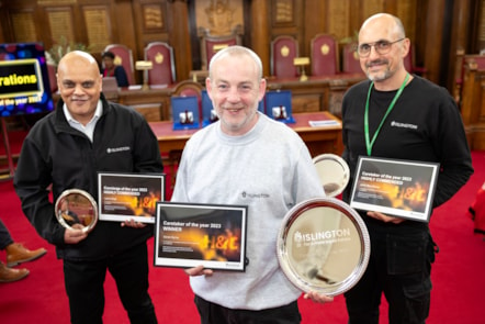 Three men in Islington Council uniforms stand smiling and holding their winners' plates and certificates.