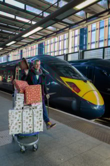 Peter Jenkinson, Toyologist, with gifts for Demelza about to leave London, St Pancras: Peter Jenkinson, Toyologist, with gifts for Demelza about to leave London, St Pancras