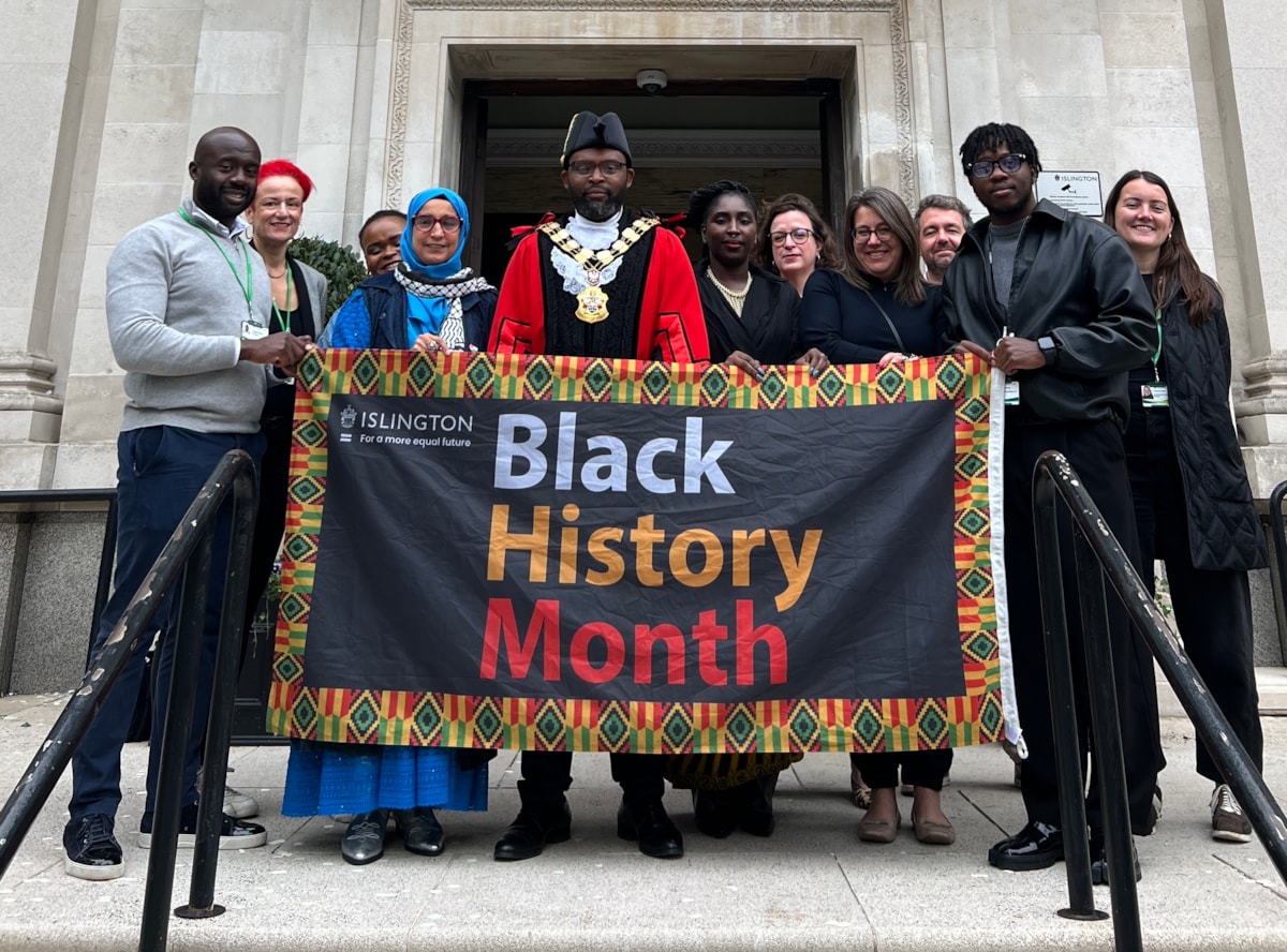 Councillors and council staff with the Black History Month flag outside Islington Town Hall