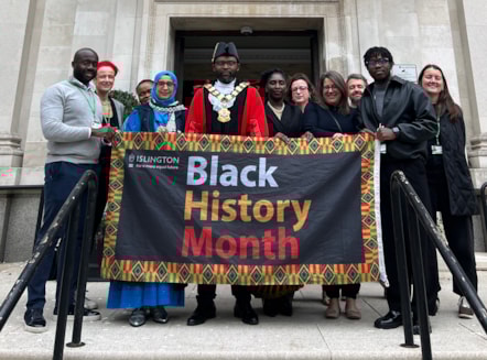 Councillors and council staff with the Black History Month flag outside Islington Town Hall