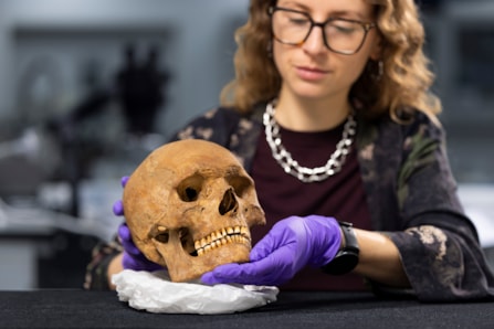 Dr Jess Thompson examines the skull of a man from Roman Scotland. Photo © Duncan McGlynn (1)