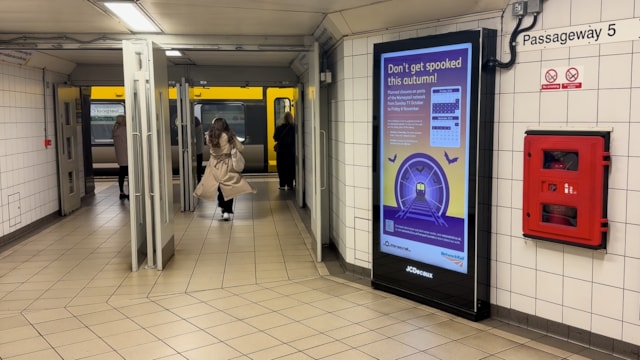 The entrance to a Wirral line platform with a tunnel upgrades poster on display: The entrance to a Wirral line platform with a tunnel upgrades poster on display