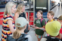 Sara Pascoe talking to children on London St Pancras platform ahead of journey to York