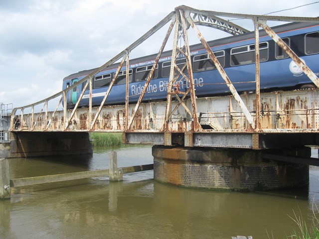 Reedham swing bridge: A National Express East Anglia train passes over Reedham swing bridge in Norfolk.