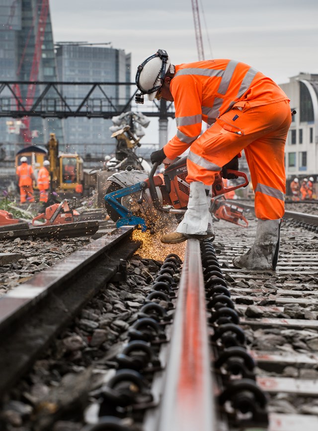 London Bridge August 2015: Conductor rail cutting in the rain at London Bridge as part of the Thameslink Programme