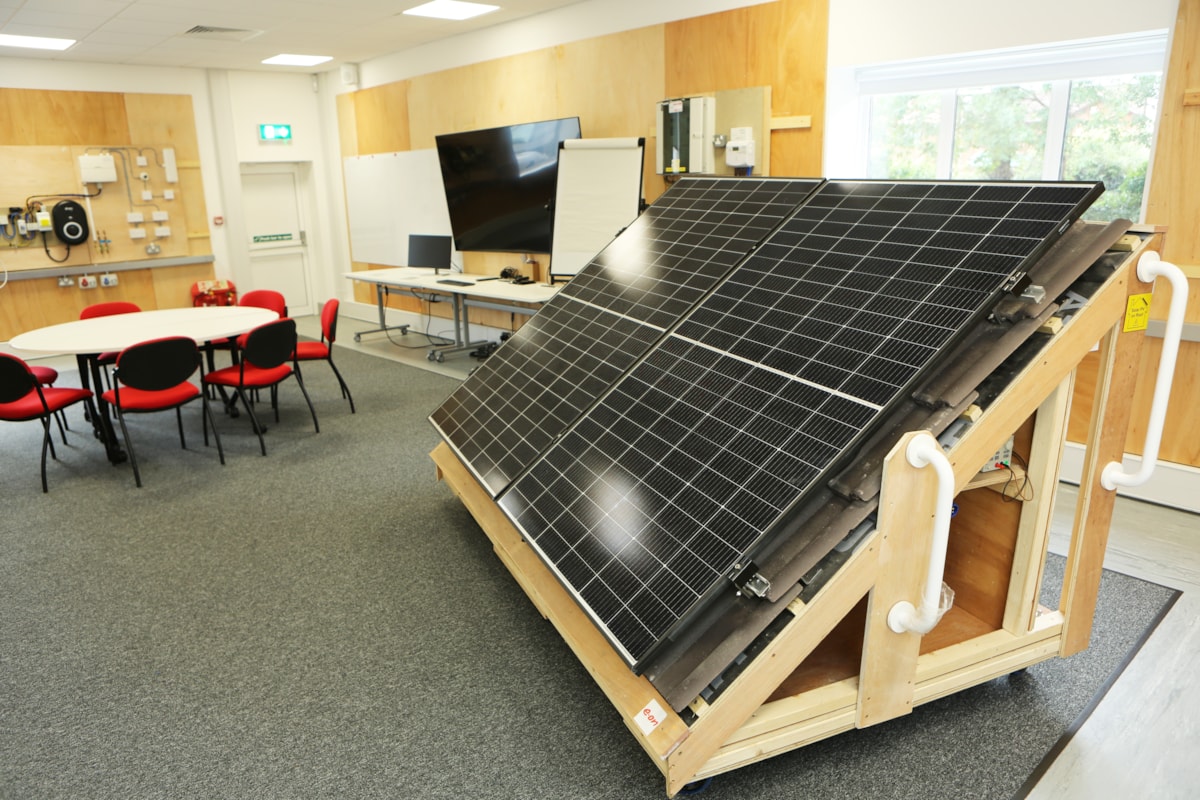 Training room at E.ON's Net Zero training academy in Kingswinford, UK, featuring solar panel and electrical vehicle charging training equipment.