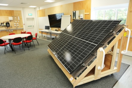 Training room at E.ON's Net Zero training academy in Kingswinford, UK, featuring solar panel and electrical vehicle charging training equipment.