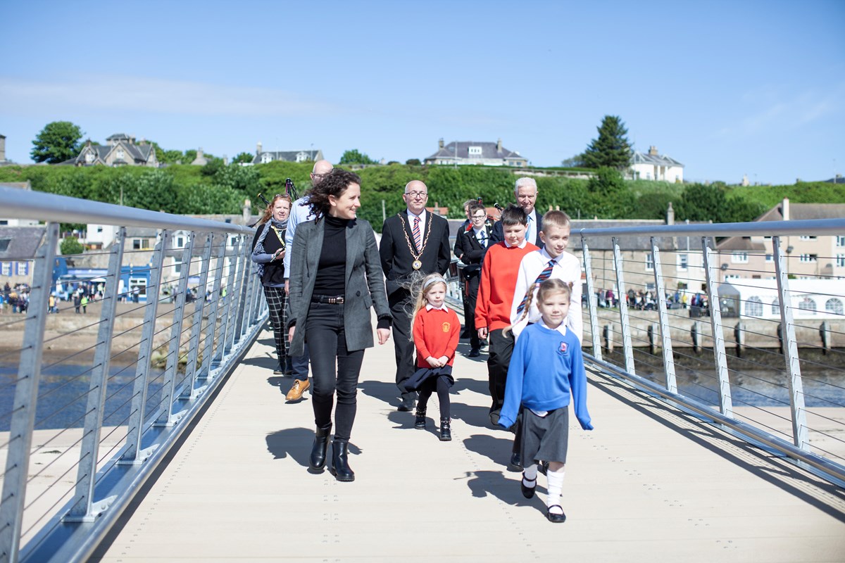 L-R Cabinet Secretary for Rural Affairs and Islands, Mairi Gougeon MSP; Moray Council Convener, Cllr Marc Macrae; Alan McDonald (Chair Lossiemouth Community Development Trust); Lola Thomson and Aiden Ingram from St Gerardine Primary School; Jordan Muir and Ruby Watts from Hythehill Primary School.