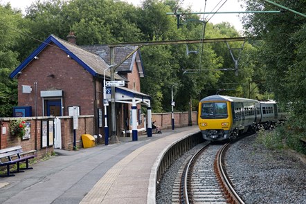 Image shows passenger sat at station as Northern train arrives