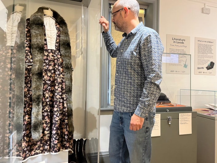 Literature in Leeds: Curator Patrick Bourne with a dress created as part of theatre show and exhibition Corseted, which centred around the life and work of radical Leeds suffragist Alice Cliff Scatcherd.
The dress is based on one worn by Alice when she opened the Morley Friends Adult School in 1894 and sits alongside objects chosen by writer and performer, Becky Cherriman, whose own work touches on themes such as women’s history and industrial working conditions.